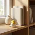Decorative items including a vase, books, and a small figurine on a wooden shelf.