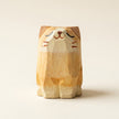 Wooden cat figurine on a beige background