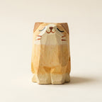 Wooden cat figurine on a beige background
